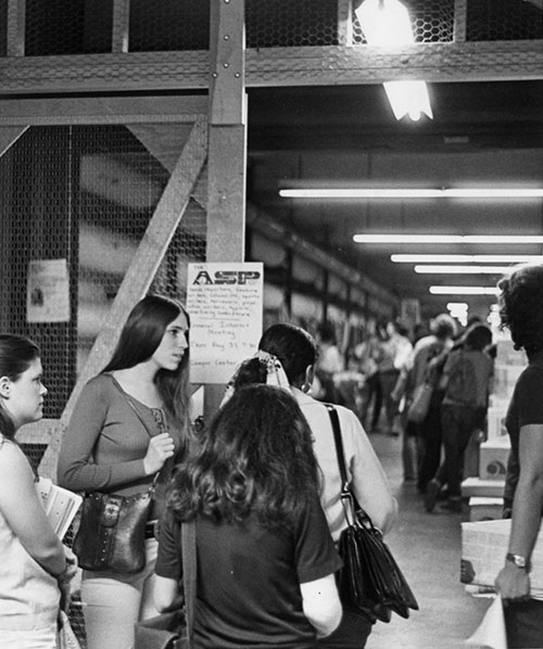 Students walk through book sale in the tunnels.